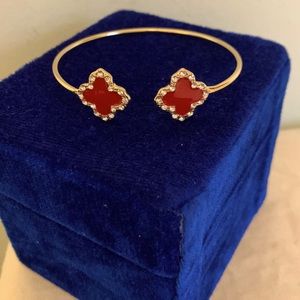 Crimson red enamel clovers accented with crystals and gold plated bracelet. NWOT